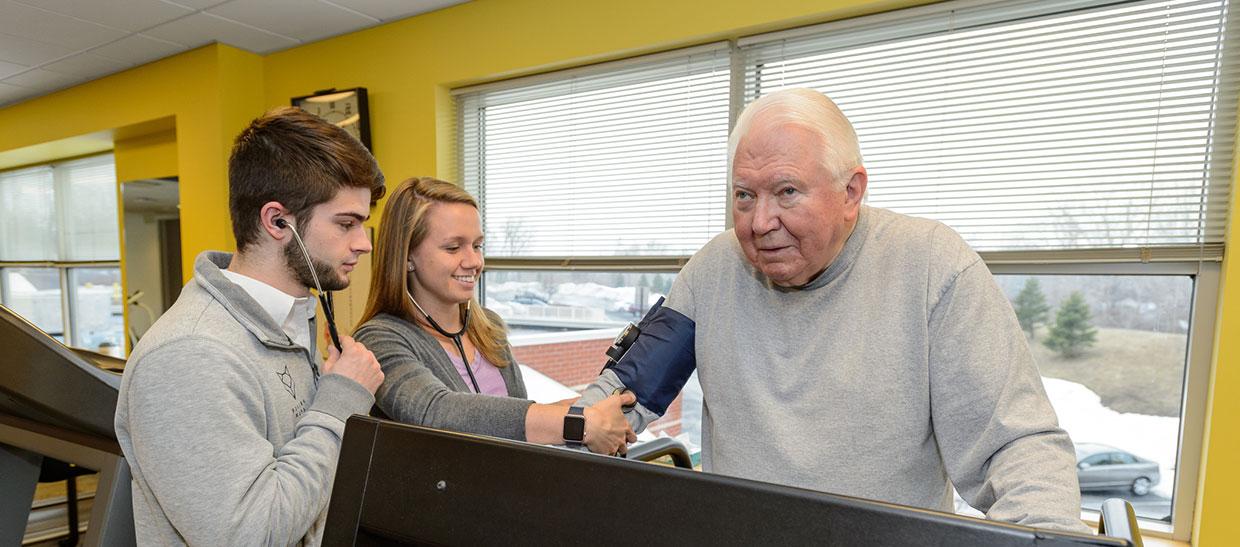 Trainer working with patient on treadmill